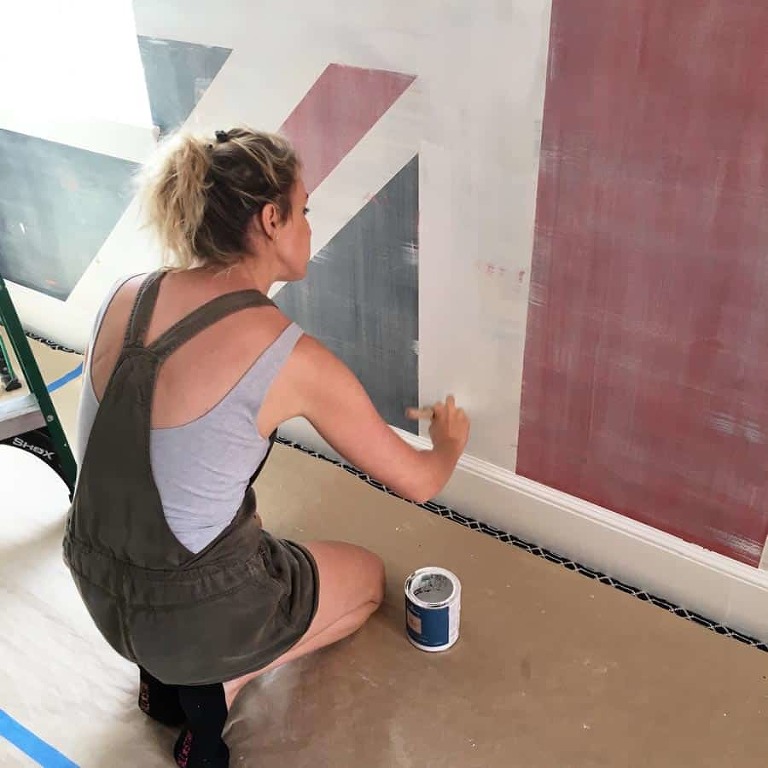 Jessica Kollar painting a mural